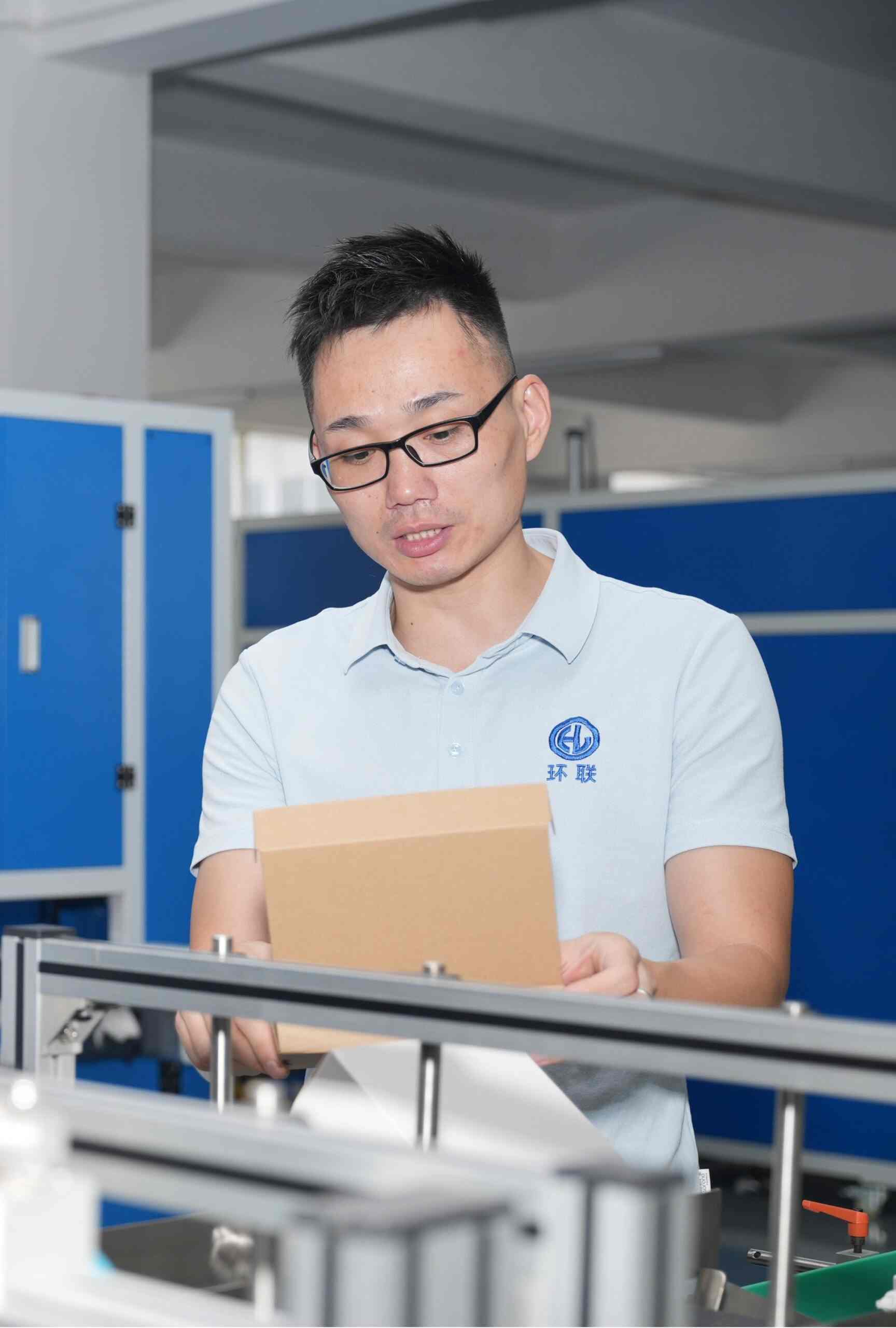 Staff working on the carton folding machine
