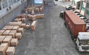 UBL’s equipment shipping preparation area: A large quantity of wooden-crated industrial equipment is neatly arranged here, and a container truck (with a forklift on standby) has been positioned on-site, fully ready for cargo loading and shipment