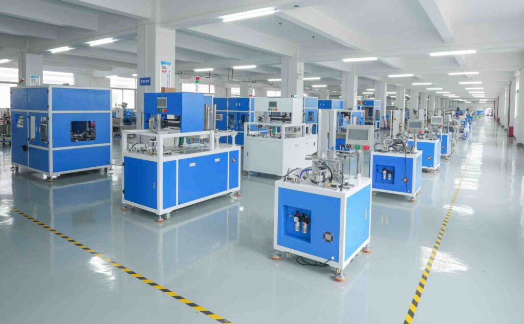 UBL’s box folding machine production workshop: Blue-and-white box folding machines are neatly arranged in the spacious, bright and well-organized production facility, ready for quality inspection and customer delivery