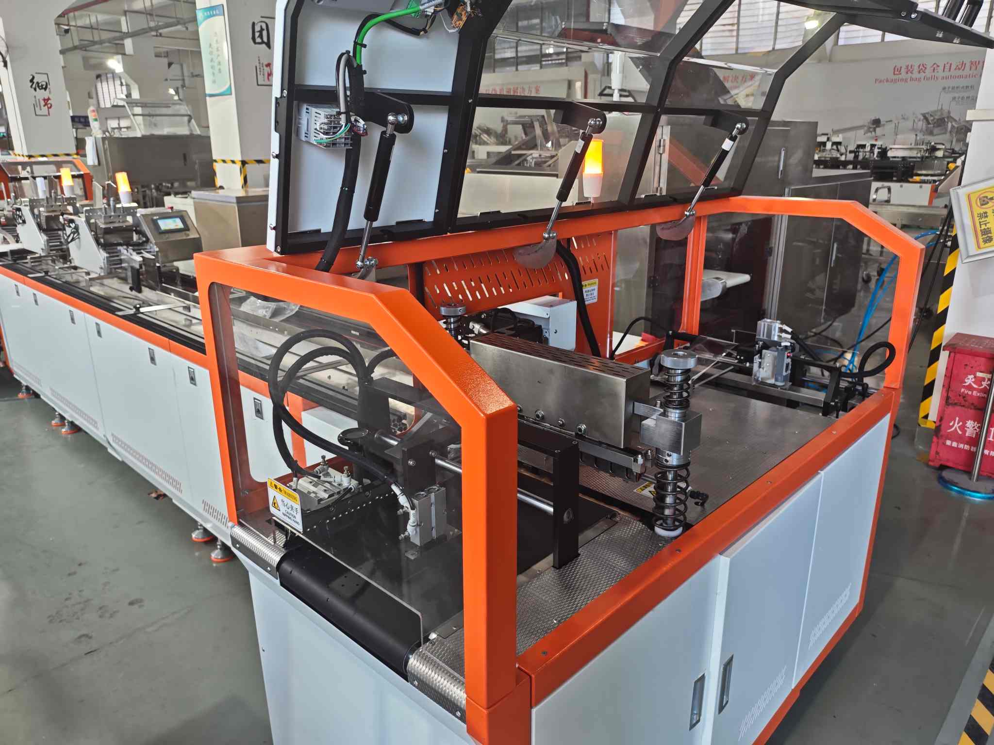 UBL bagging machine with 304 stainless steel body and modular design, featuring a 10-inch HD touch control interface, fully enclosed safety cover, and emergency stop button, ideal for automated packaging in e-commerce warehouses, food, and pharmaceutical production lines.