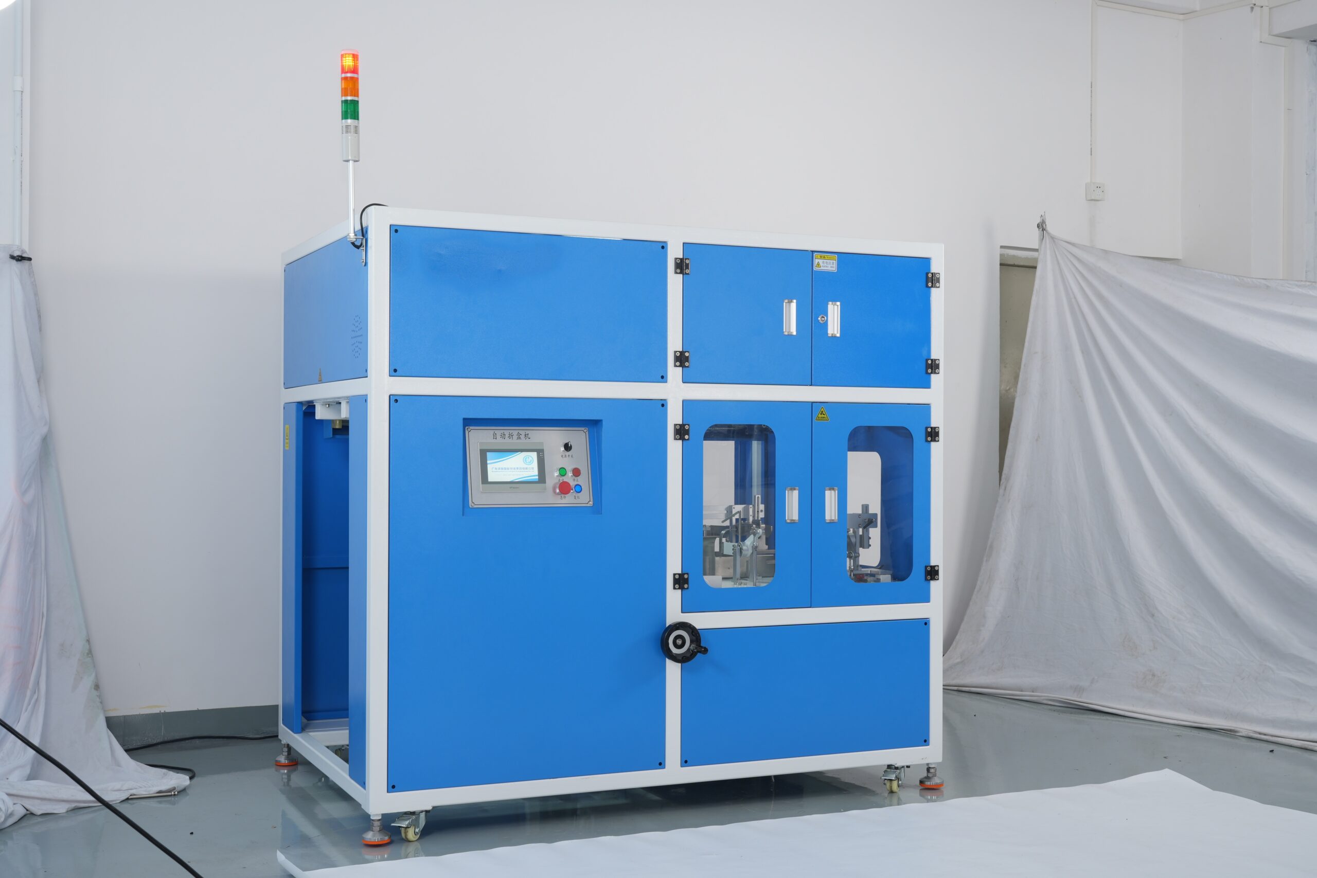 Food Packaging Snap Lock Bottom Box Machine: Blue-and-white automatic box forming equipment for producing snap lock bottom boxes in food packaging, featuring an operation screen, signal warning light, and transparent observation windows for monitoring the box-making process