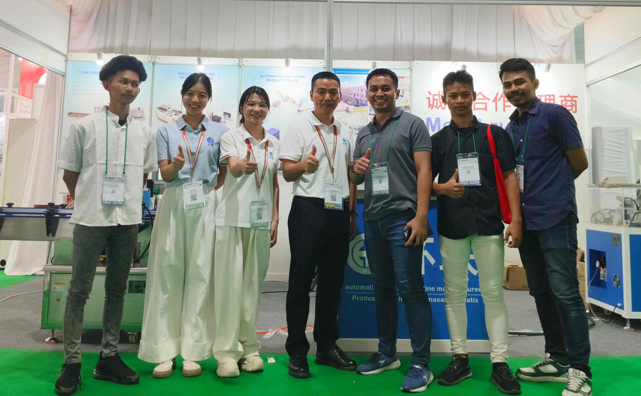 UBL team & potential partners at a trade show booth: Featuring 'Recruit Cooperative Agents' signage, our staff and prospective collaborators pose together at the exhibition stand focused on packaging equipment solutions