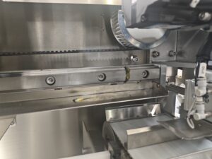 Close-up of a cartoning machine conveyor belt.