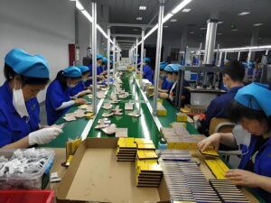 E-commerce Packaging Manual Labor Scene - Workers Assembling Paper Cartons on Production Line for E-commerce Consumer Goods Packaging