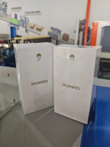 Automated Pouch Loading Systems Packaging Sample - Huawei Product Boxes on Industrial Packaging Line in Factory Workshop