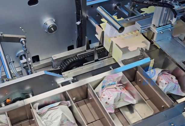 Hot Melt Glue Cartoning Machine in operation, automatically loading toys into blind boxes on an automated packaging production line