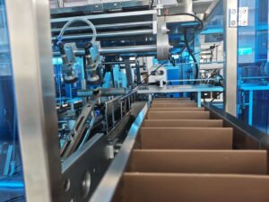 Close-up of a modular cartoning machine internal structure, featuring precision-engineered mechanical components, carton feeding rails, and automated packaging mechanisms for flexible, high-efficiency production lines.