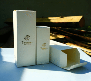 Two white cosmetic packaging boxes lying flat: one perfectly sealed, one slightly open at the top, demonstrating manual packaging inconsistency and the need for automated cartoning machines