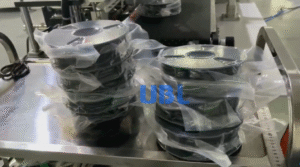 UBL semi-automatic filament packing line: Neatly stacked 3D printing filament spools wrapped in vacuum-sealed packaging to protect from moisture.