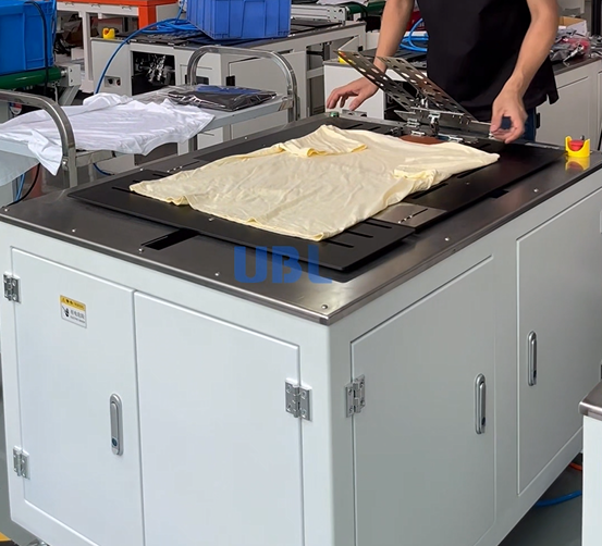 UBL single-station semi-automatic clothes folding machine, compact and small-sized, for efficient garment folding in small-scale production.