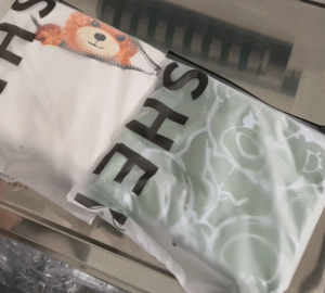 UBL pre-made bag garment folding machine automatically folds and packs t-shirts into custom customer-provided bags.