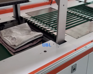 UBL automatic garment folding and stacking system neatly stacks folded T-shirts and clothes on the conveyor belt