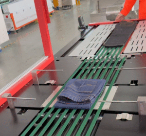 UBL automatic jeans folding machine folds denim jeans neatly on the conveyor belt