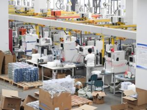 Packaging machine workshop, end-of-line packaging system for towel and textile products. The design of end-of-line packaging systems starts with production capacity targets, including peak throughput, available working hours and product mix, to match cartoner, case packer and palletizer.