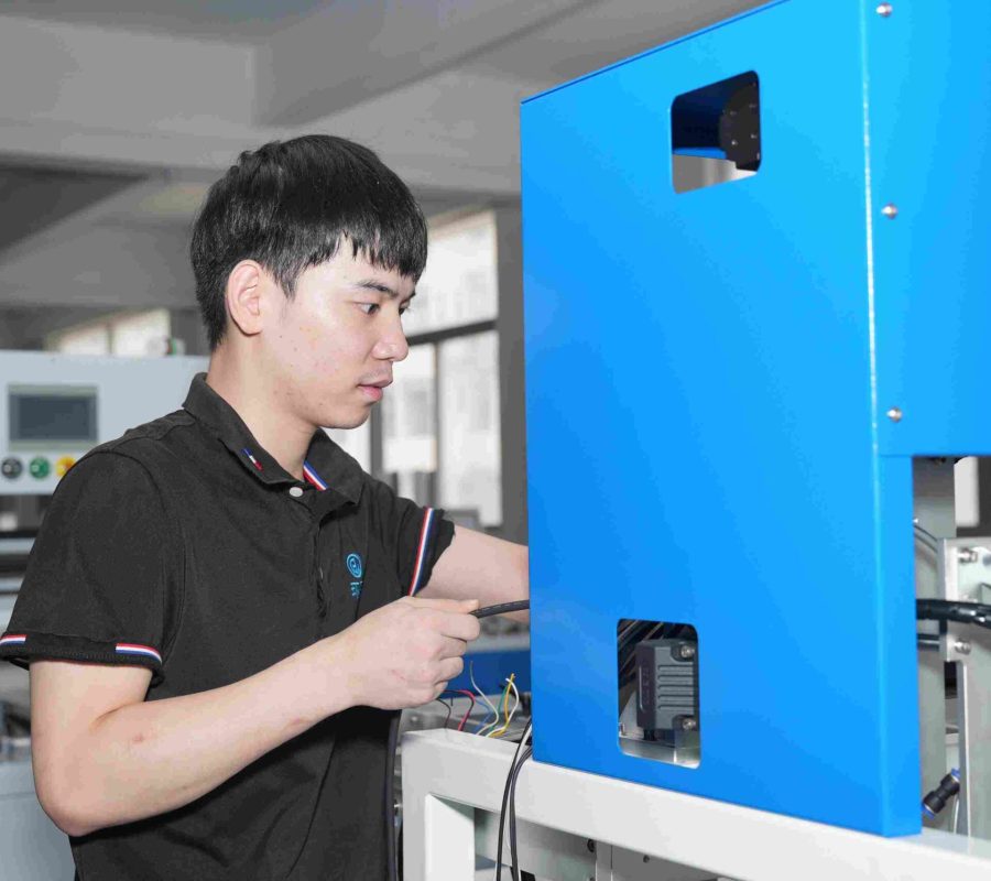 A technician is repairing a Folder Gluer machine, ensuring its stable operation for high-quality box folding and gluing.